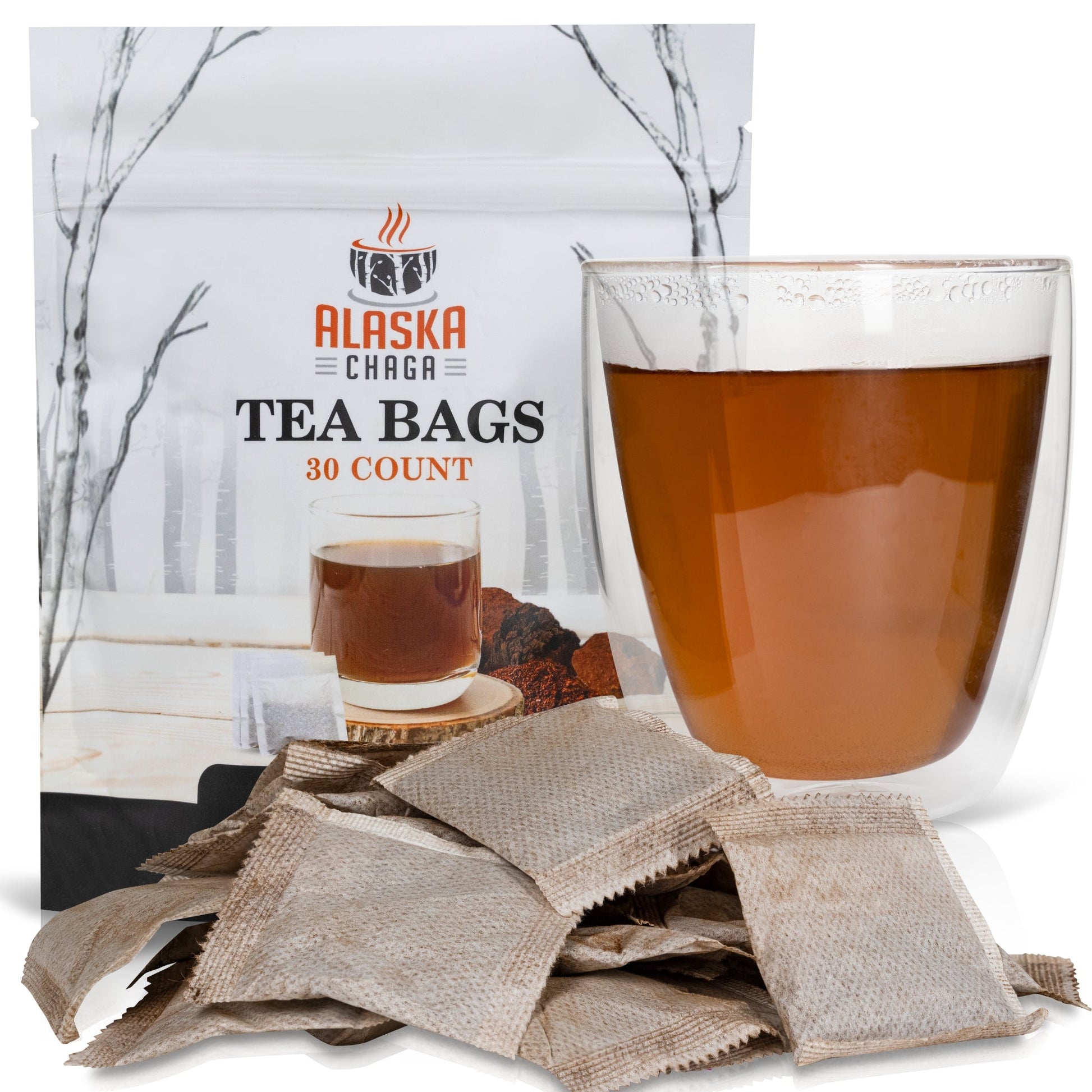 Alaska Chaga tea bags pouch with a glass of brewed chaga and loose tea bags